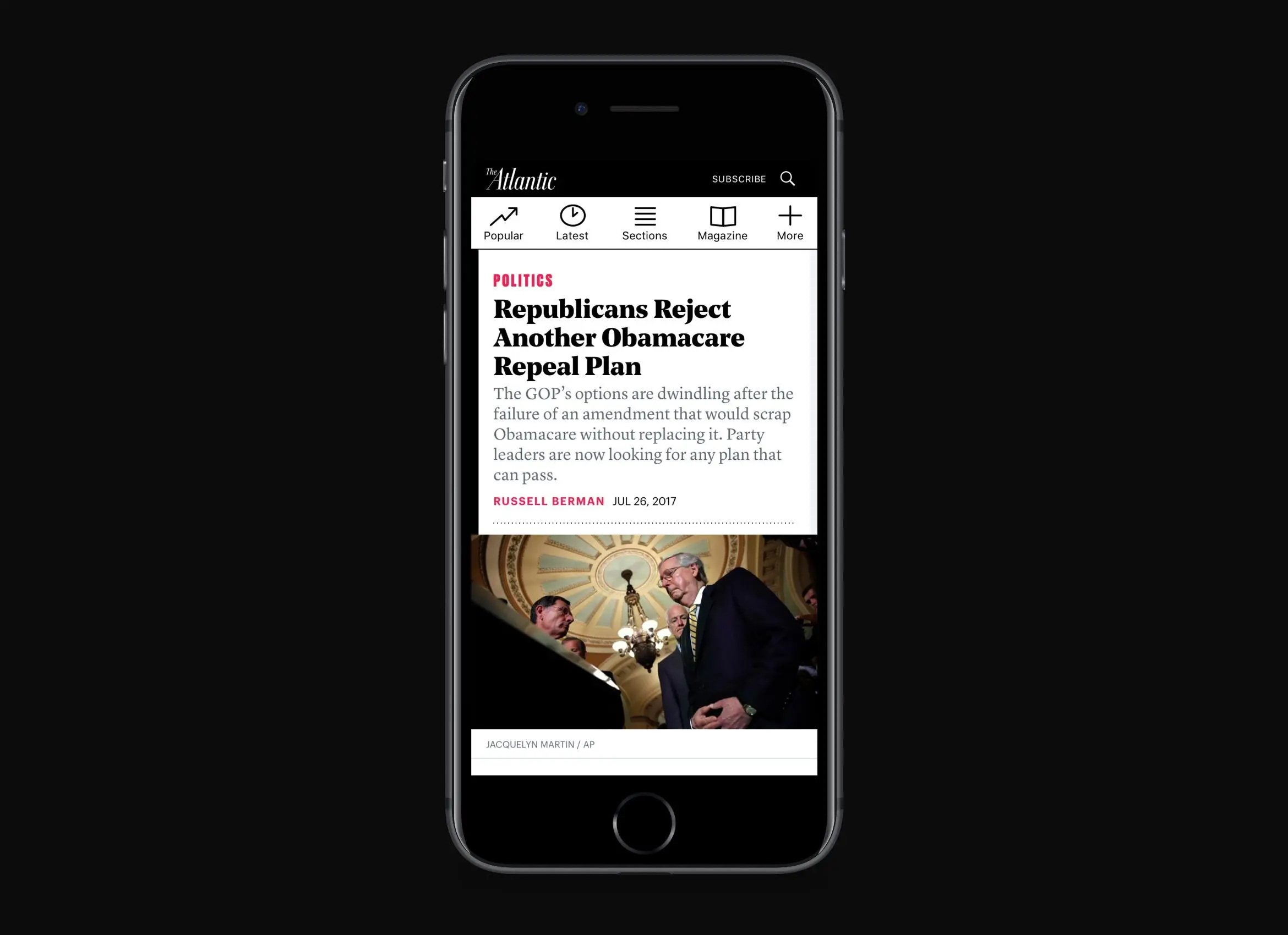 The Atlantic article page on an iPhone against a dark background